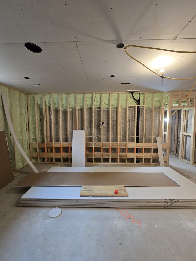 Bare wall framing with wiring run through it during a home automation installation